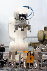 Smart factory concept: Industrial robot with gripper unit in automation machine