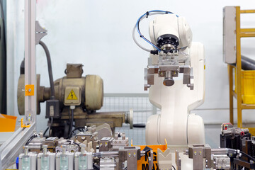 Smart factory concept: Industrial robot with gripper unit in automation machine