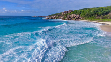 Amazing aerial view of Grand Anse in La Digue Island, Seychelles. Ocean and forest