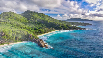 Naklejka na ściany i meble Amazing aerial view of Grand Anse in La Digue Island, Seychelles. Ocean and forest