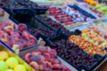 blurred background, fruits in boxes on sale