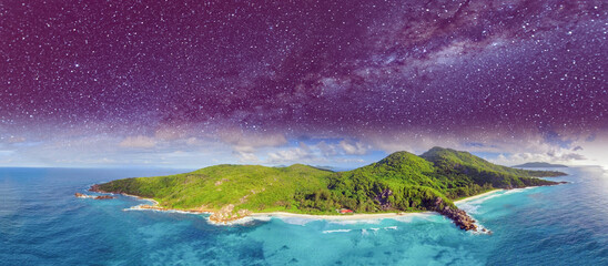 Aerial panoramic view of Tropical Island at night with stars and milky way