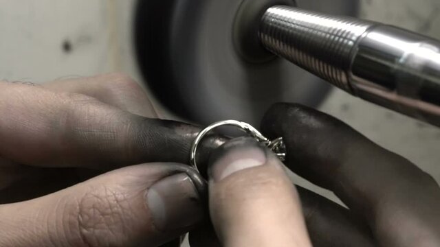polishing diamond solitaire ring jeweler master. Craftsman hand made diamond ring product. closu up macro shooting close up