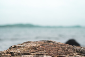 Selective focus od black stone texture for put product to show with beach background.