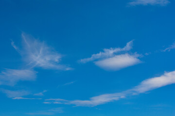 Naklejka na ściany i meble Snow-white clouds against a blue sky