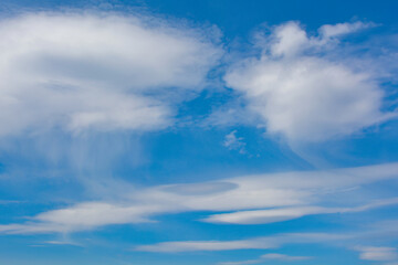Naklejka na ściany i meble Snow-white clouds against a blue sky