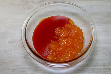 Ingredients to make sauce for apricot chicken casserole. Equal parts of russian dressing and apricot preserves.