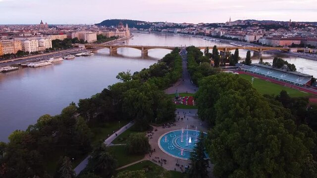 Aerial view of musical fontain show,chain bridge and hungarian parliament in background during golden hour