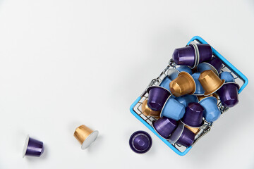 Caffeine, hot drinks and objects concept - close up blue, purple and golden capsules or pods for...