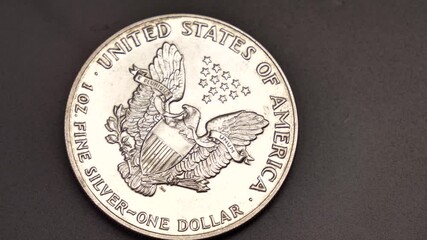 Silver dollar and an American flag Cash . Finance, investment concept and crisis . Closeup shot Silver 1oz - Powered by Adobe