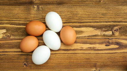 Chicken egg and duck egg on a wooden table.