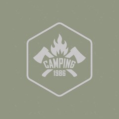 Color illustration for text, crossed axes, fire on a background with texture. Vector illustration of a camping logo in vintage style with a grunge texture. Wildlife travel illustration.