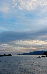 Naklejka na ściany i meble View of dawn at the seaside with the dramatic sky, boat and mountain, Tioman Island