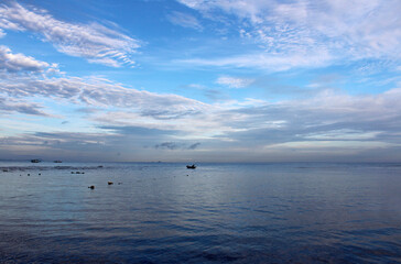 Obraz premium View of dawn at the seaside with a man on the boat, Tioman Island