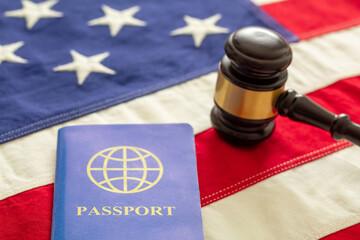 Blue passport and law gavel on USA flag background, close up view.