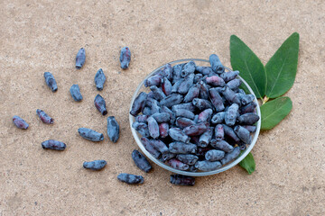 honeysuckle berries on a concrete background.
