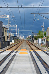 Fototapeta premium Train railway track with power cables in the local railway station in Japan.