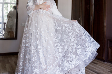 Fototapeta na wymiar bride in a wedding dress in morning in the room