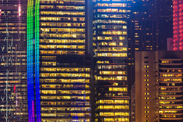 Close up colourful modern high rise building view from the Kowloon at night time in Hong Kong.
