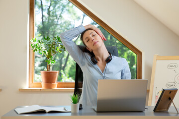 Beautiful women performing exercises and stretching in front of a laptop. Working at home, health...