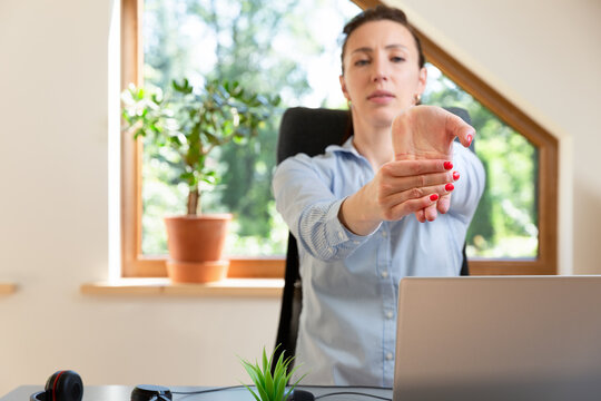 Beautiful women performing exercises and stretching in front of a laptop. Working at home, health concept.