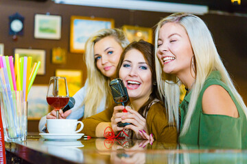 Women singing with microphone