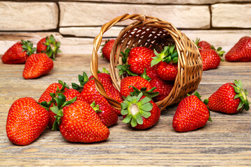 Ripe fresh strawberry in basket. Scattered berries