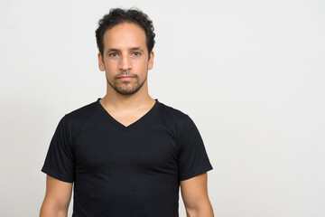 Portrait of handsome bearded Hispanic man with curly hair