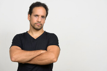 Portrait of handsome bearded Hispanic man with curly hair