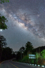 The beautiful Milky way over the road in the dark night.