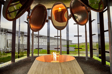Fototapeta na wymiar Vardo, Norway - 23 June 2019: Stylized bonfire and mirrors in a black cubic building with glass in the Museum a memorial dedicated to burned at the stake and dead witches in time of witch hunt.