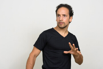 Portrait of handsome bearded Hispanic man with curly hair