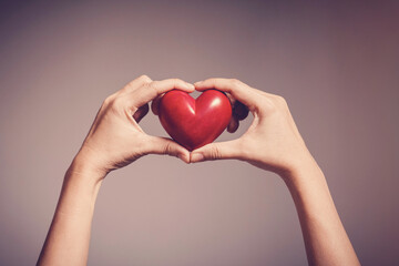 Woman holding red heart, health insurance, donation, happy charity volunteer concept, world mental...