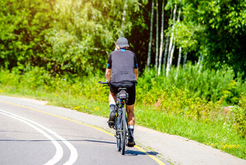 Cyclist ride on the bike path in the city Park
