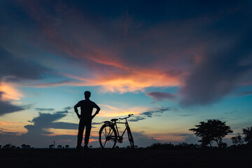 Fototapeta na wymiar silhouette of a man riding a bicycle