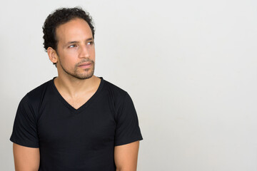 Fototapeta premium Portrait of handsome bearded Hispanic man with curly hair