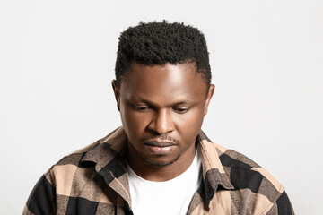 Obraz premium Sad African-American man on light background. Stop racism