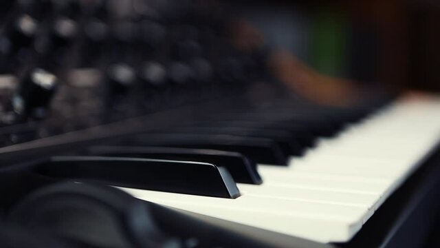 Analog synthesizer piano keyboard video clip.Dj store sell professional midi controller device with black & white keys.Electronic musical instrument for music production in sound recording studio