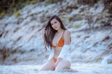 Portrait beautiful young  model asian woman wearing swimming suite  bikini  posing sexy feel happy on the sea ocean beach for leisure travel vacation on summer season.
