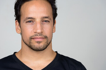 Obraz premium Portrait of handsome bearded Hispanic man with curly hair