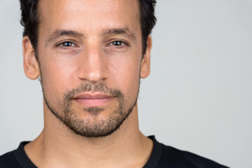 Portrait of handsome bearded Hispanic man with curly hair