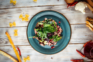 Salad with greens meat and pomegranate