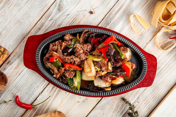 Beef in cast-iron pan with vegetables