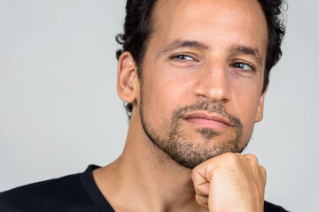 Portrait of handsome bearded Hispanic man with curly hair