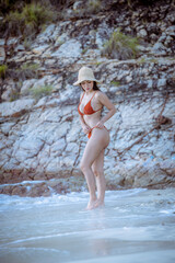 Fototapeta premium Portrait beautiful young model asian woman wearing swimming suite bikini posing sexy feel happy on the sea ocean beach for leisure travel vacation on summer season. 