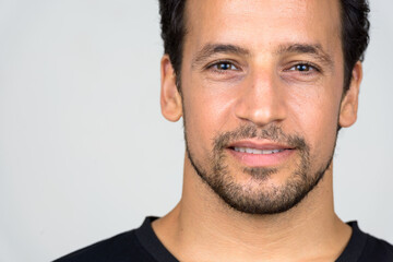 Portrait of handsome bearded Hispanic man with curly hair