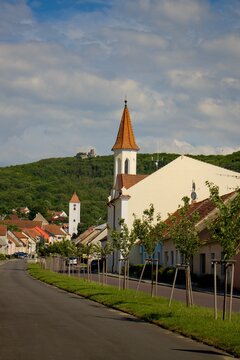 The streets of the colorful wine-growing village of Perná, in the background the ruins of the castle Sirotčí hrádek (Orphan's small castle), region of Morava, Czechia, middle Europe