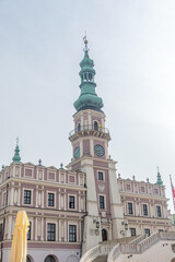 Fototapeta na wymiar Clock Tower of Town Hall at Great Market Square (Rynek Wielki) in Zamosc.