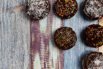 several chocolate cupcakes with decorations on the top and right side of the image