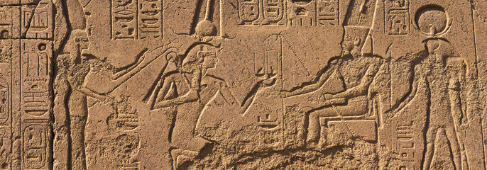 Karnak Temple, Colossal sculptures of ancient Egypt in the Nile Valley in Luxor, Embossed hieroglyphs on the wall.
